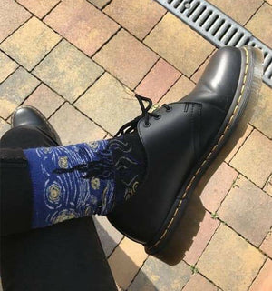 Qorapa LaraLara crew socks featuring a Starry Night inspired impressionist print worn with black leather boots
