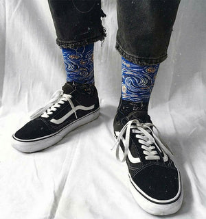 Qorapa LaraLara crew socks featuring a blue Starry Night impressionist print worn with black sneakers and jeans.