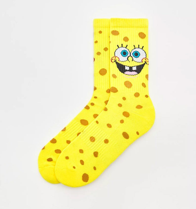 Qorapa LaraLara yellow SpongeBob SquarePants crew socks with brown porous spots and character face detail