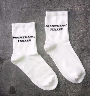 Qorapa LaraLara white crew socks with black Professional Stalker text embroidery in a soft cotton-blend fabric.