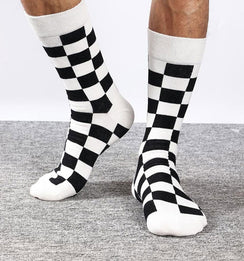 Qorapa LaraLara crew socks featuring a black and white checkered pattern with white cuffs, heel, and toe.