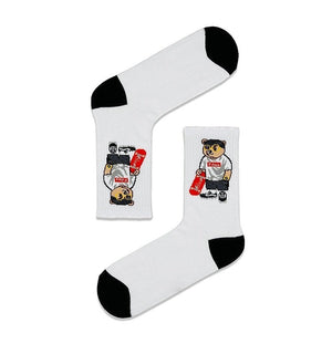 Qorapa LaraLara white crew socks featuring a graphic of a bear holding a skateboard with black toe and heel accents.