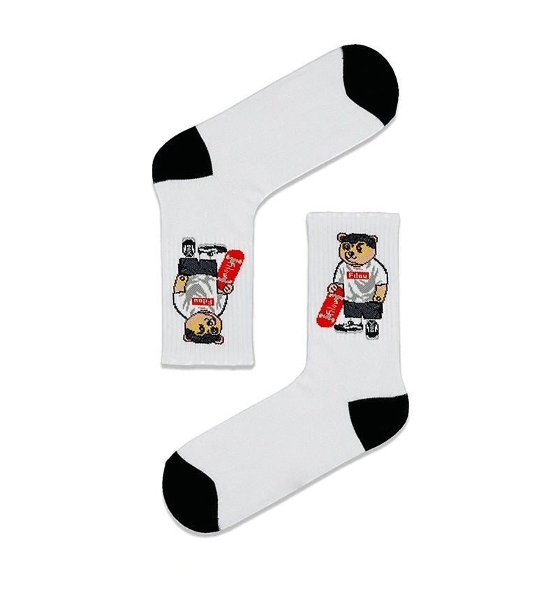 Qorapa LaraLara white crew socks featuring a graphic of a bear holding a skateboard with black toe and heel accents.