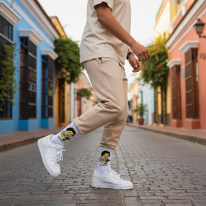 Qorapa LaraLara white crew socks with cartoon graphic, worn by a person in beige joggers and white sneakers on a street.