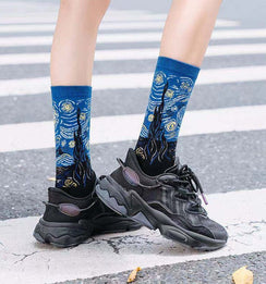 Qorapa LaraLara crew socks featuring a vibrant Starry Night impressionist print worn with black chunky sneakers