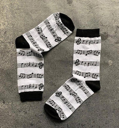 Qorapa LaraLara crew socks featuring a black and white musical note and staff pattern with reinforced black heels.