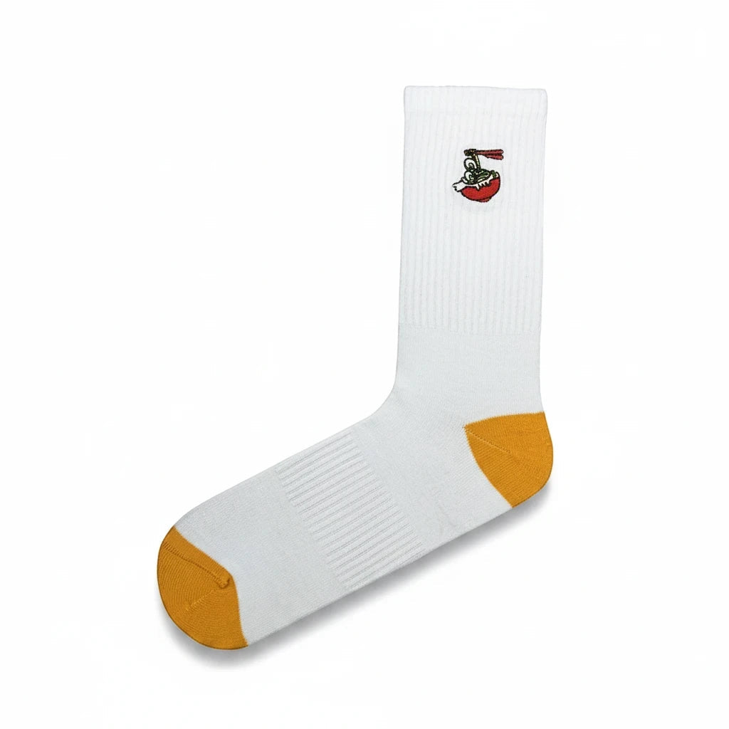 Qorapa LaraLara white crew socks featuring a small ramen bowl embroidery and mustard yellow heel and toe caps.