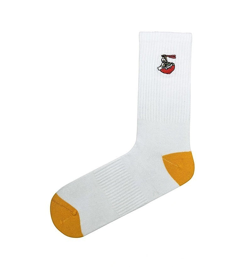 Qorapa LaraLara white crew socks featuring a small ramen bowl embroidery and mustard yellow heel and toe caps.