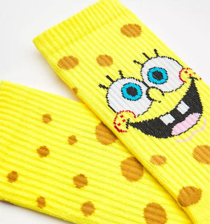 Qorapa LaraLara yellow SpongeBob SquarePants crew socks with a porous pattern and a cheerful character face design.