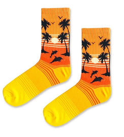 Qorapa LaraLara crew socks featuring a vibrant tropical sunset, palm trees, and dolphins in orange and yellow.
